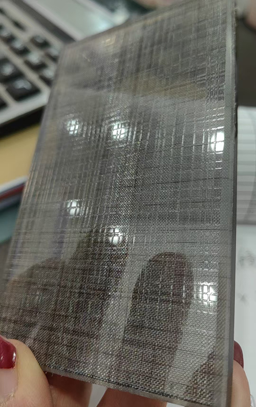 clear acid etched architectural glass with fabric laminated glass